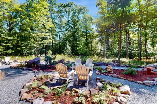 three chairs and a table in a garden at The Frank Lloyd Wright Home @ Deep Creek, MD in Bittinger