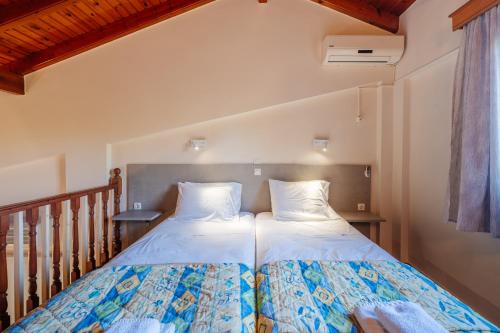 a bedroom with a bed with two pillows at Spyridoula Resort in Corfu in Gouvia