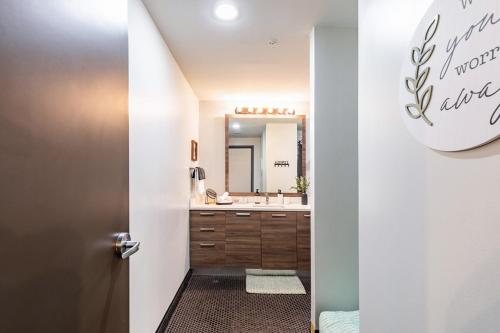 a bathroom with a sink and a mirror at Modern-Chic Loft in Heart of Dallas in Dallas