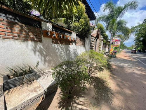 a building with a sign on the side of a street at NEW BAMBOO'S Airport Transit Hotel in Katunayake