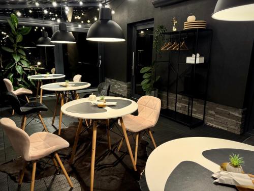 a group of tables and chairs in a restaurant at Vila GARUFA Wellness & Spa in Vysoké Tatry