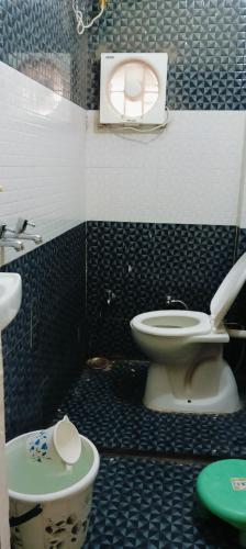 a bathroom with a toilet and a sink at Radhike STAY in Varanasi