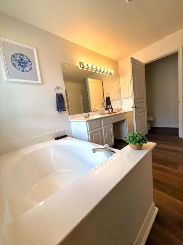 a large white bathroom with a large bath tub at Minutes from Sea World and Fiesta Texas in San Antonio