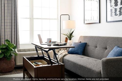 a living room with a couch and a coffee table at InTown Suites Extended Stay Atlanta GA - KSU Kennesaw in Kennesaw