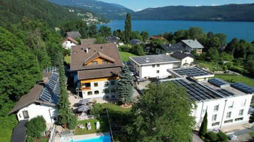 an aerial view of a house with a pool at Familienhotel Steindl in Millstatt