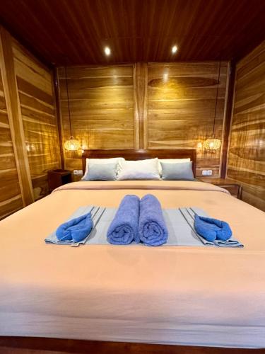 a bedroom with a bed with blue towels on it at Dream Makers Retreat in Gili Islands