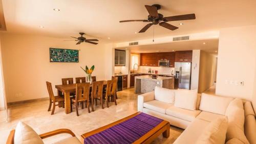 a living room with a couch and a table at Luxury 2 bedroom condo by the beach in Tangolunda