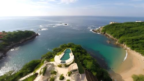 an aerial view of a boat on a beach at Luxury 2 bedroom condo by the beach in Tangolunda