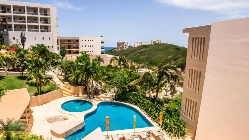 an overhead view of a swimming pool at a resort at Luxury 2 bedroom condo by the beach in Tangolunda