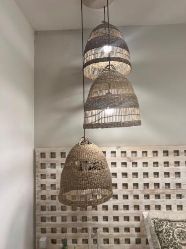 three baskets hanging from the ceiling in a room at Pousada Estrela do Norte in Pipa