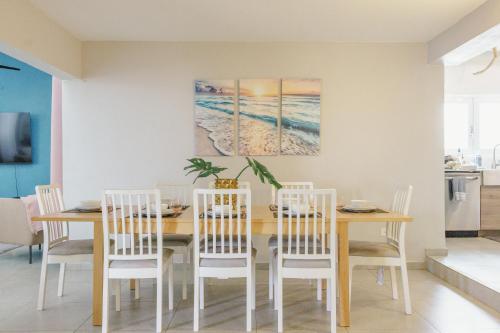 a dining room with a table and chairs at Signature's Dorado Relaxing Villa in Dorado