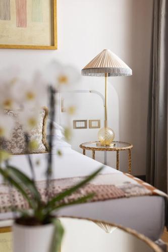 a bedroom with a bed and a table with a lamp at Hotel Gabrielli Venezia - Starhotels Collezione in Venice