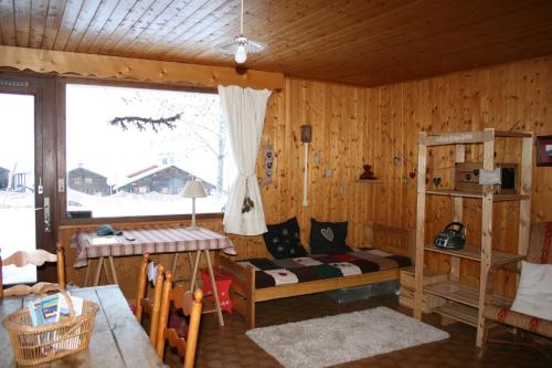 a bedroom with a bunk bed and a window at Les Myosotis in Arêches