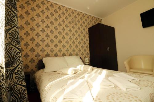 a bedroom with a bed with towels on it at Pokoje Gościnne Anna Airport Modlin in Nowy Dwór Mazowiecki