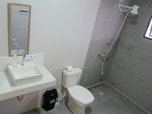 a bathroom with a toilet and a sink and a shower at Quarto vista mar São Sebastião in São Sebastião