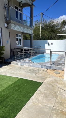 a swimming pool in the backyard of a house at Bonzour Tropical Apartments l 2 Bedrooms l Pool l Equipped kitchen l Cosy l Trou aux Biches l Mauritius in Trou aux Biches