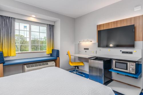 a hotel room with a bed and a desk at Microtel Inn and Suites Montgomery in Montgomery