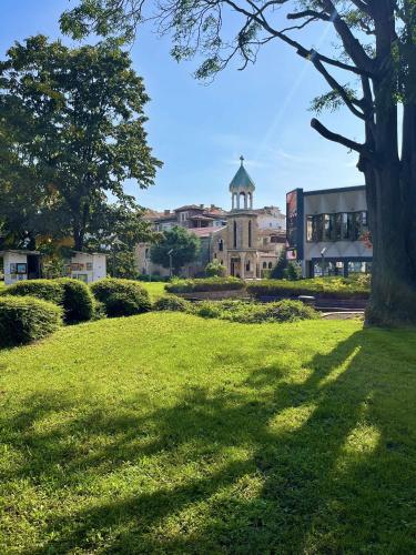 a field of grass with a building with a tower at Centrino in Burgas