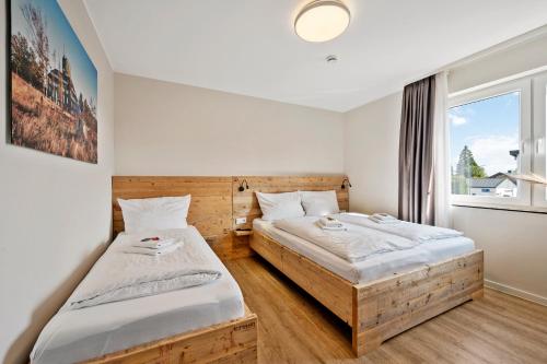 Postel nebo postele na pokoji v ubytování SNOWFLAKE Zentrale Lage Bikepark & Piste