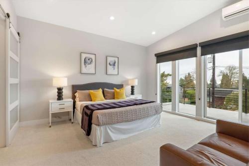 a bedroom with a large bed with yellow pillows at New House with Chef's Kitchen and Spa-like Suite in Seattle