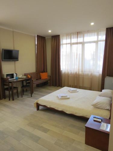 a hotel room with a large bed and a couch at Just comfort in Odesa
