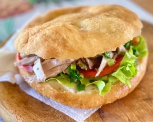 a sandwich sitting on top of a wooden cutting board at Villabadlou Ti-Colibri in Trois-Rivières