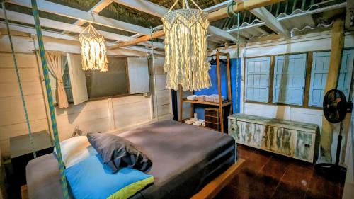 a bedroom with a bed in a room with a chandelier at Casa Corazón in El Cuyo