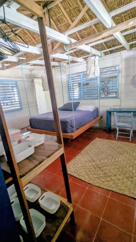 a room with a bed and a desk and a table at Casa Corazón in El Cuyo