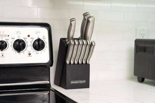 two knives in a knife block on a kitchen counter at Charming 3-Bed House with Hot Tub close to Downtown in Barrie