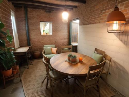 a dining room with a wooden table and chairs at Ethlyn House in Bocas del Toro