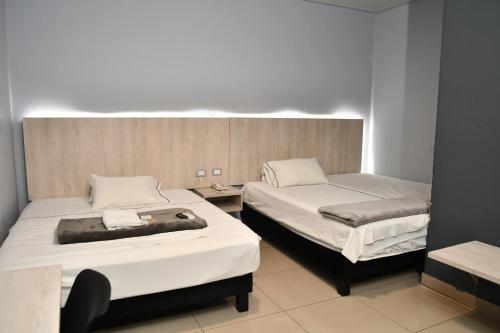 a room with two beds in a room at HOTEL NABU DEL PACIFICO in Tumaco
