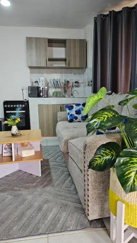 a living room with a couch and a table at Executive Studio in Juja