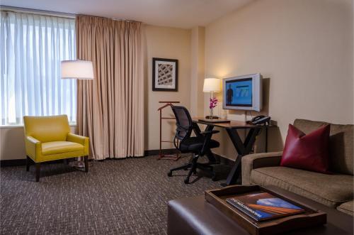 a living room with a couch and a desk in a hotel room at Beacon Hotel & Corporate Quarters in Washington