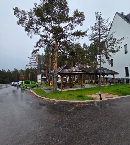 a building with a gazebo next to a parking lot at Green Hill Isidorovic Divcibare in Divčibare