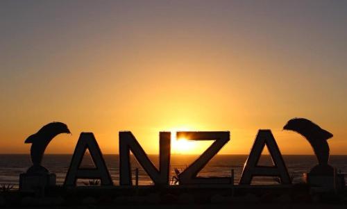 a sunset over the ocean with the word akril in front at Dar Diafa Anza in Agadir