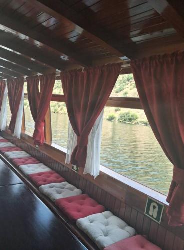 a row of seats in a boat on the water at Casa do Vale Encantado in Cedovim