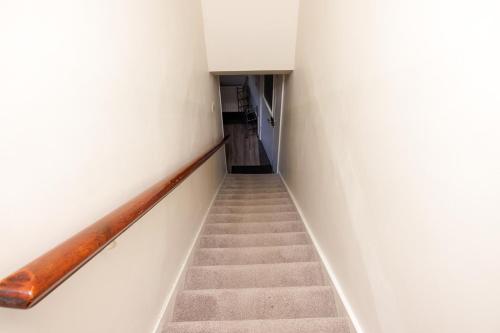 a staircase in a room with white walls at North Harbour View in Lerwick