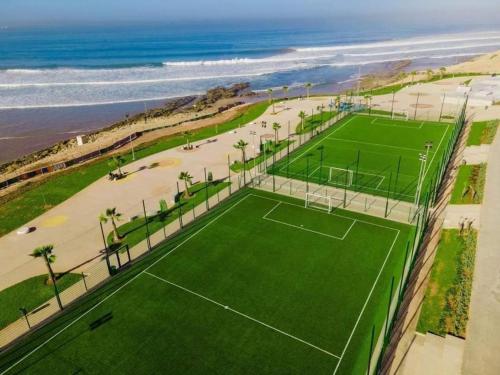 an aerial view of a tennis court next to the beach at Dar Diafa Anza in Agadir