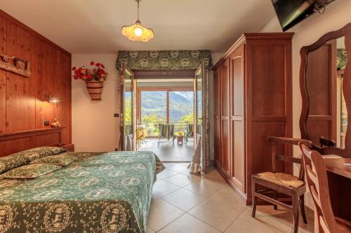 a bedroom with a bed and a door to a patio at Affittacamere Verger Plein Soleil in Saint-Pierre