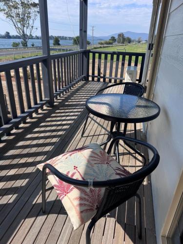 a balcony with a table and a table and chairs at Entire home near South West Rocks Beautiful Views in Pelican Island