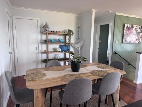 a dining room with a wooden table and chairs at Entire home near South West Rocks Beautiful Views in Pelican Island