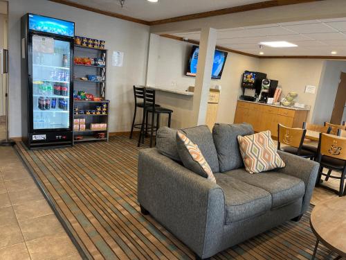 a living room with a couch and a large screen at Quality Inn Arena in Wilkes-Barre