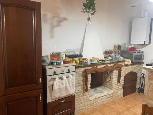 a kitchen with an oven and a counter with food on it at B&B I Giardini in Pieve Torina