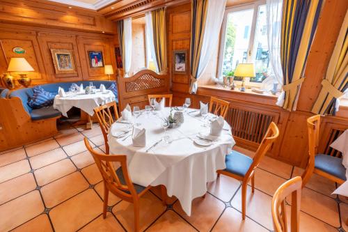a dining room with two tables and chairs and a window at Hotel-Restaurant Schwanen in Weil am Rhein