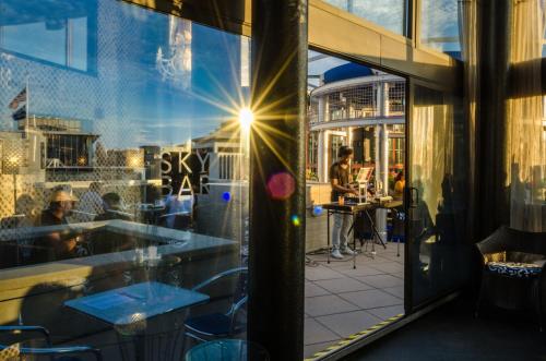a window of a restaurant with a man sitting at a table at Beacon Hotel & Corporate Quarters in Washington