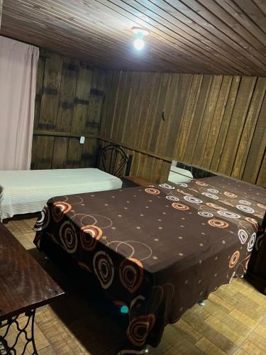 Ένα ή περισσότερα κρεβάτια σε δωμάτιο στο Casa Cabana Harmonia