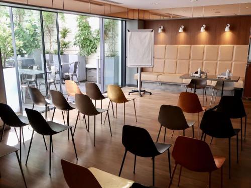 a restaurant with chairs and tables in a room at Boutet Bastille Hotel Paris - MGallery Collection in Paris