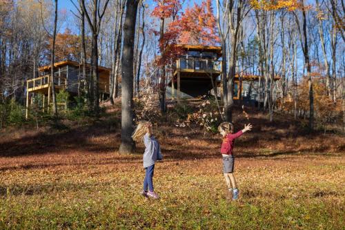 two children playing with a kite in a field at Piedmont Grove Lodging in Roseland