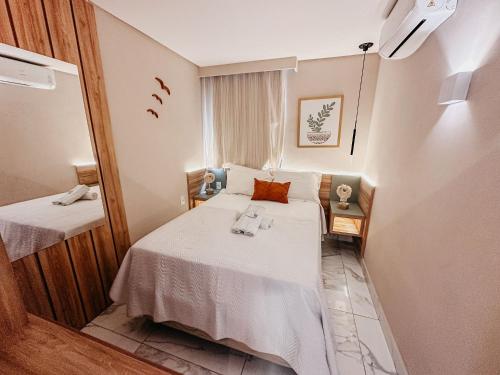 a small room with a bed and a mirror at Porto Atlantis by You In | 80m from Porto de Galinhas Beach in Porto De Galinhas