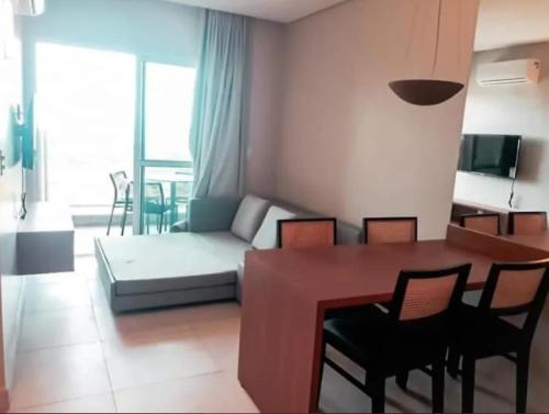 a living room with a table and chairs and a couch at Salinas Exclusive in Salinópolis